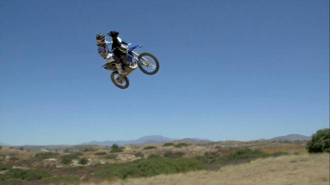 FMX rider pulls off crazy stunt with dog image