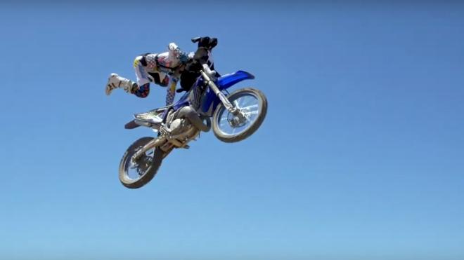 FMX rider pulls off crazy stunt with dog image
