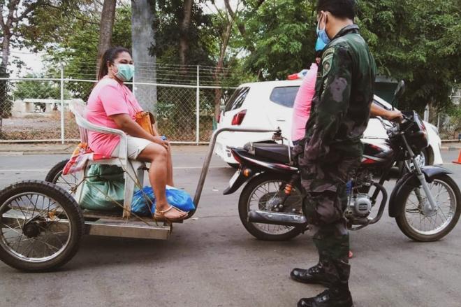 Indian rider extends motorcycle, follows social distancing image