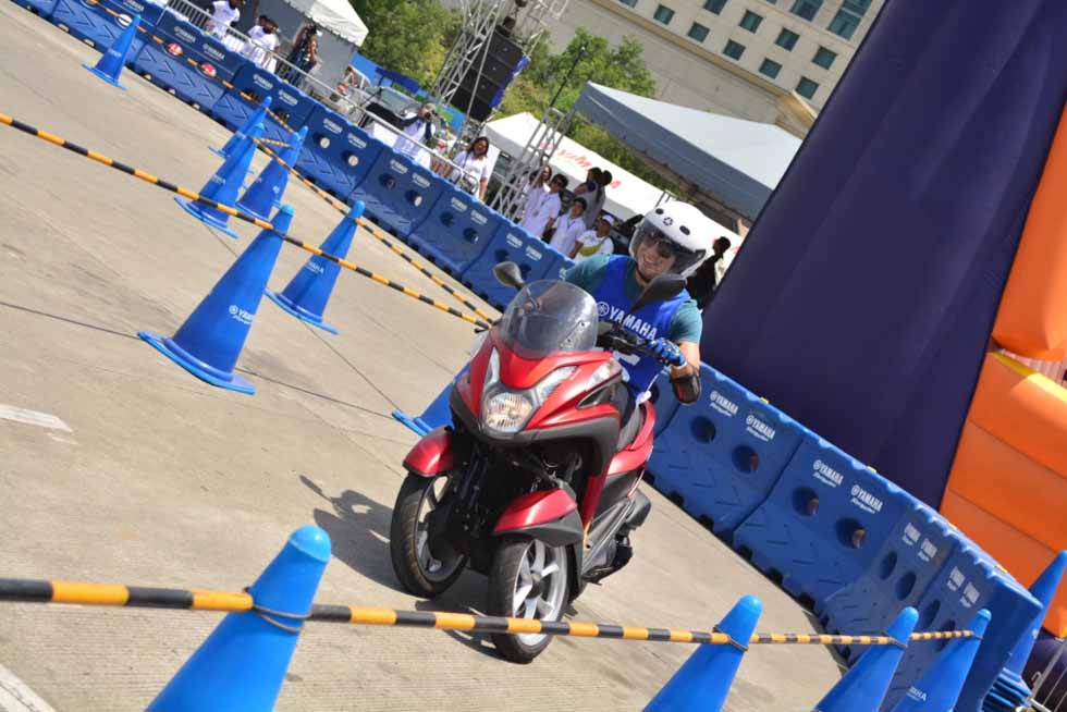 A rider takes the Yamaha Tricity through a training course