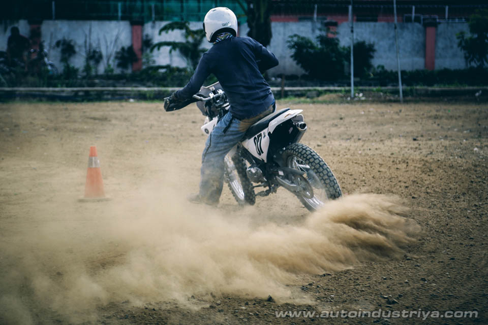 An instructor watches on how the bikers go around the course